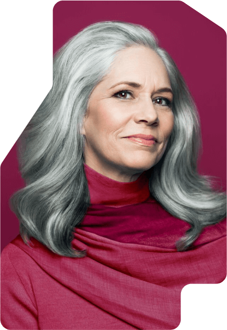 A confident older woman with gray hair smiles softly to the camera.